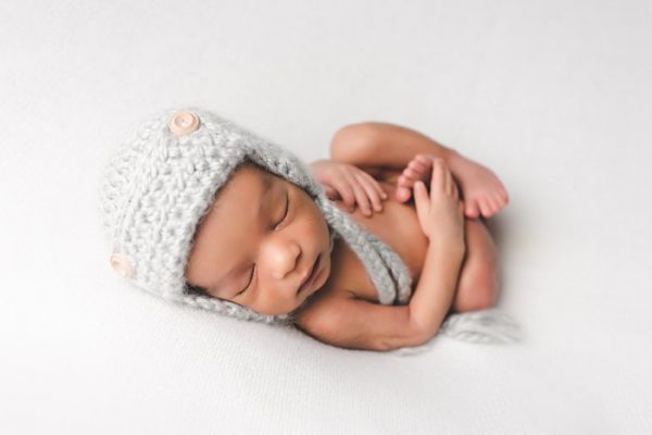 newborn baby wearing gray crochet hat