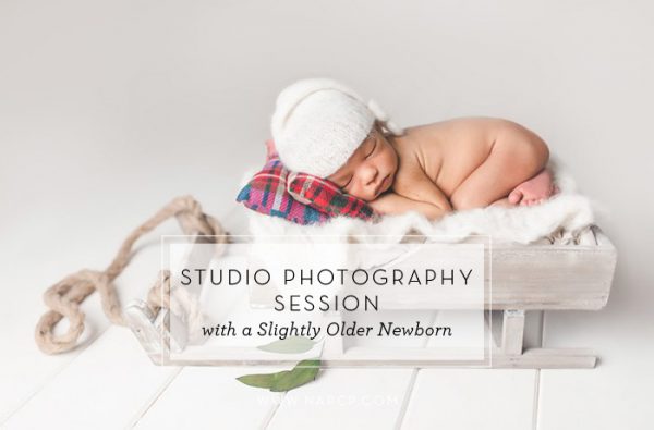 studio photography session with slightly older newborn