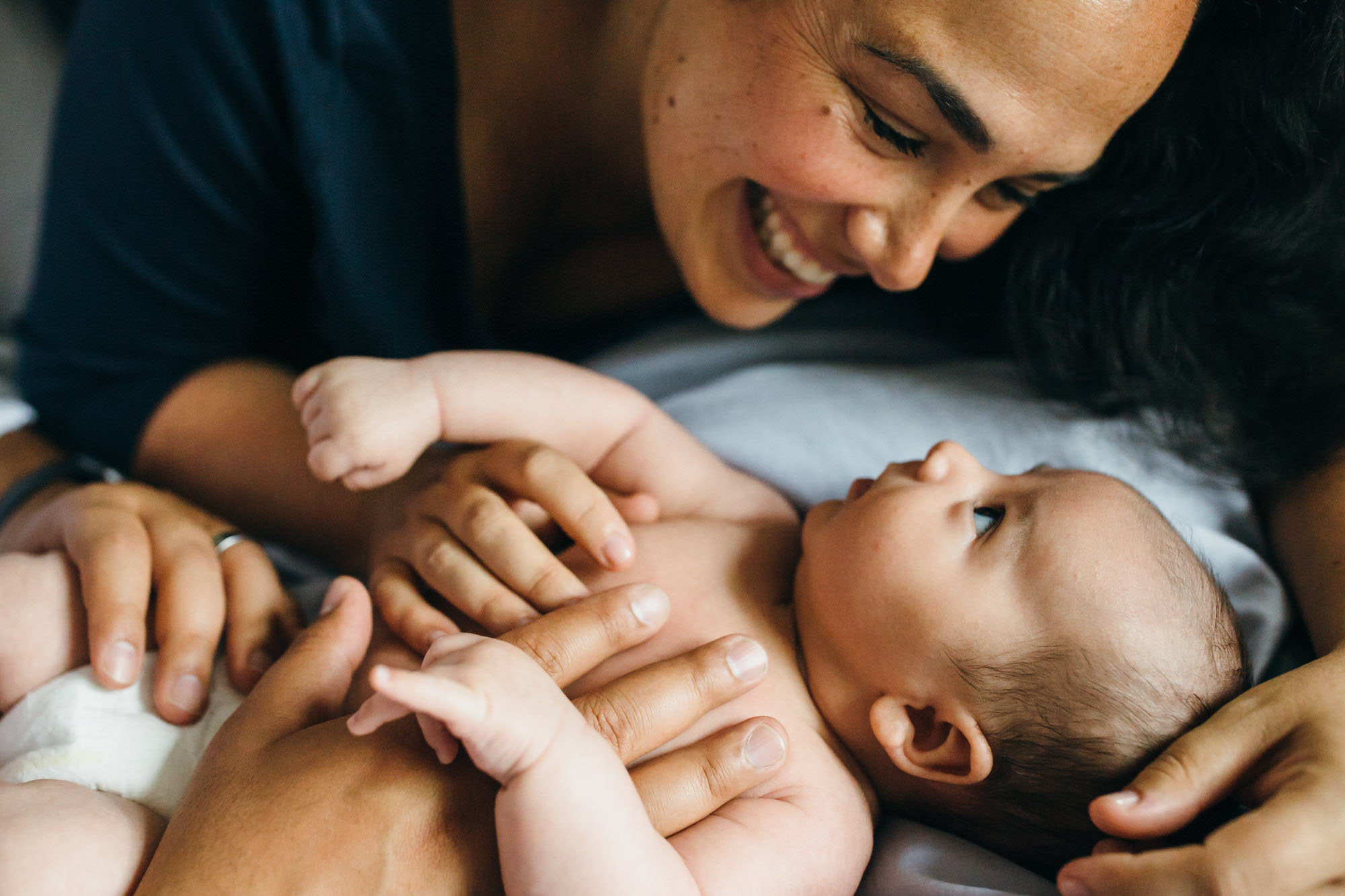 mother smiling at infant, newborn lifestyle photography, Beth Ann Fricker