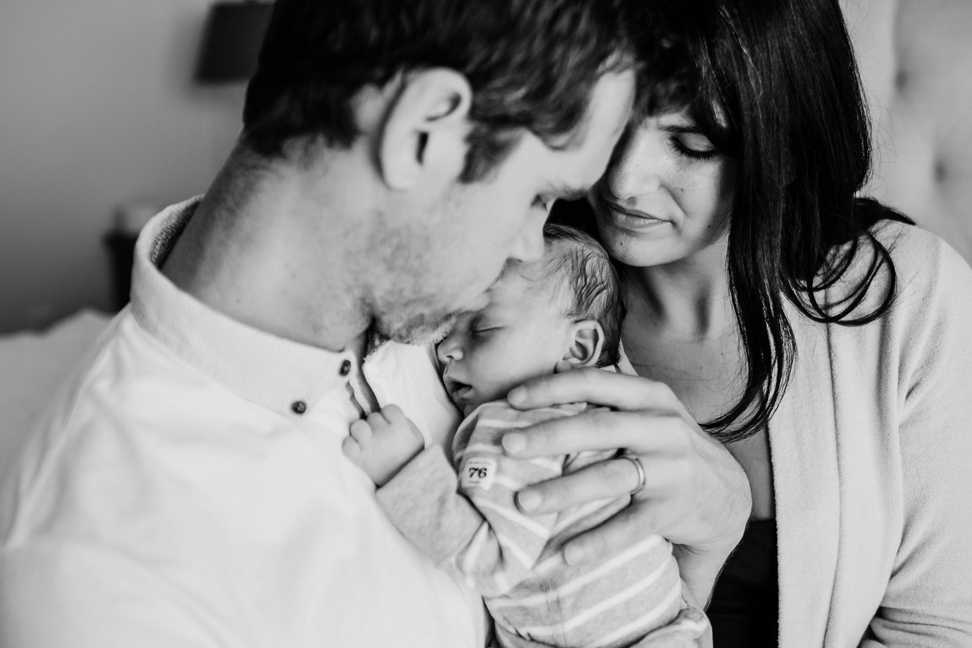 father holding infant, mother, newborn lifestyle photography